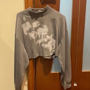 Cropped sweater with graffiti print.